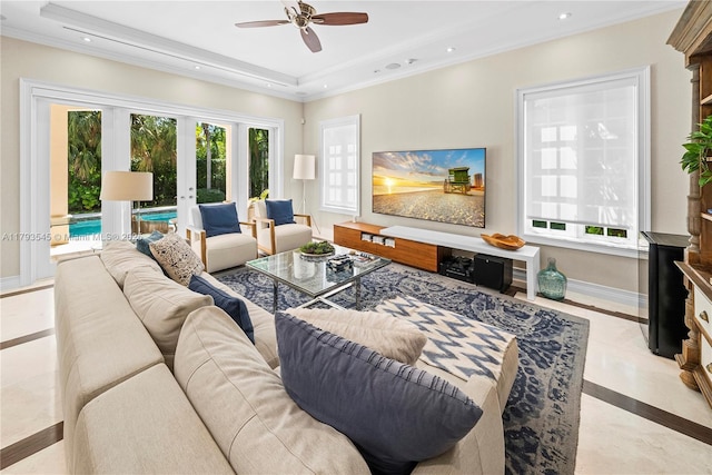living room featuring inlaid floor details, french doors, a ceiling fan, a raised ceiling, and baseboards