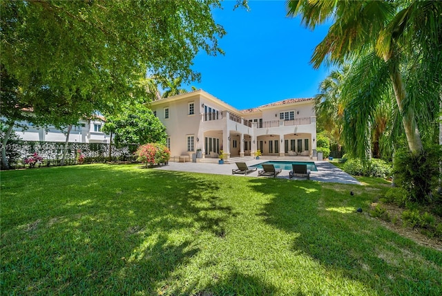 7120 Mira Flores Ave, Coral Gables, FL 33143 - back of house featuring ceiling fan, a balcony, a patio, and a yard