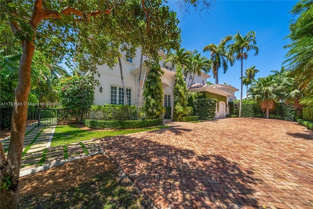 7120 Mira Flores Ave, Coral Gables, FL 33143 - view of front of property with stucco siding, a garage, and decorative driveway