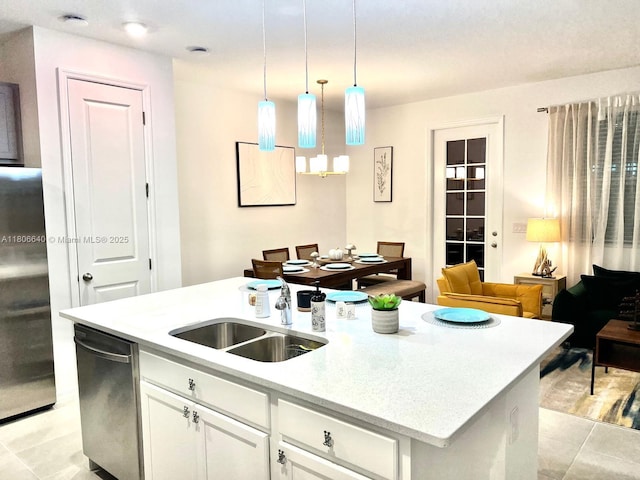 726 Longboat, Davenport, FL 33896 - kitchen with an island with sink, light tile patterned floors, stainless steel appliances, light countertops, and white cabinets