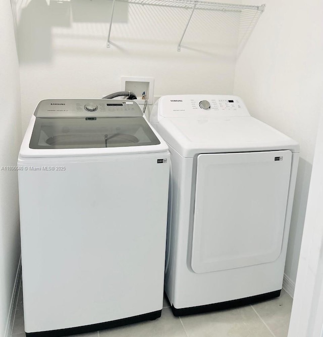 726 Longboat, Davenport, FL 33896 - laundry room with washer and dryer and light tile patterned flooring