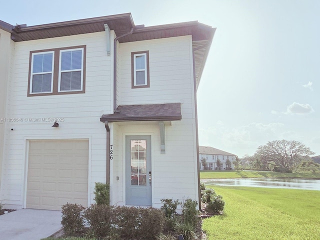 726 Longboat, Davenport, FL 33896 - townhome / multi-family property with a water view, a front yard, and an attached garage