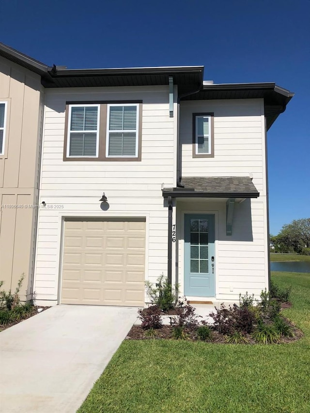 726 Longboat, Davenport, FL 33896 - traditional-style house with an attached garage, driveway, a front yard, and a water view