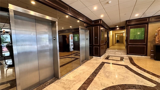625 Biltmore Way Unit 707, Coral Gables, FL 33134 - hallway featuring inlaid floor details, recessed lighting, elevator, and light marble finish flooring