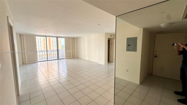 625 Biltmore Way Unit 707, Coral Gables, FL 33134 - empty room featuring expansive windows, light tile patterned floors, and electric panel