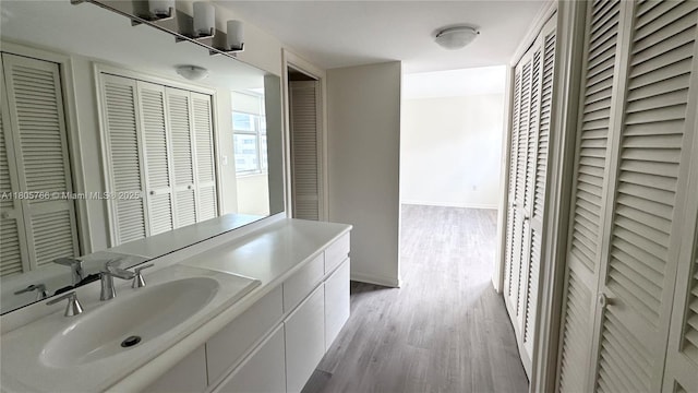 625 Biltmore Way Unit 707, Coral Gables, FL 33134 - bathroom featuring a closet, wood finished floors, and vanity