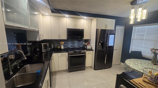 12500 SW 5th Ct Unit 307M, Pembroke Pines, FL 33027 - kitchen featuring black refrigerator with ice dispenser, stainless steel electric range, a sink, white cabinets, and dark countertops