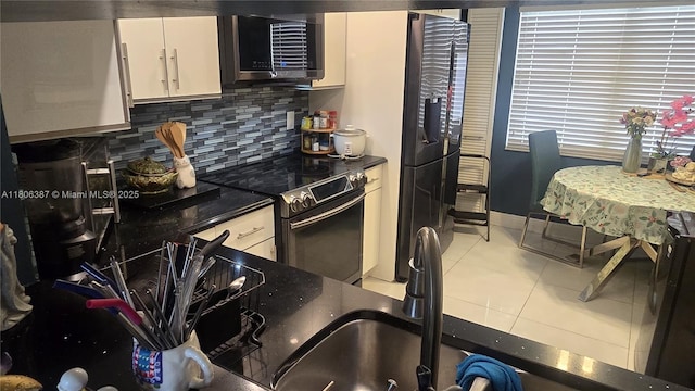 12500 SW 5th Ct Unit 307M, Pembroke Pines, FL 33027 - kitchen with stainless steel electric range oven, dark countertops, decorative backsplash, light tile patterned floors, and refrigerator with ice dispenser