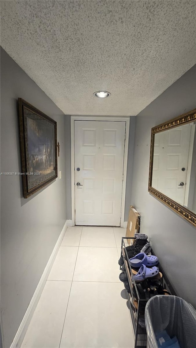12500 SW 5th Ct Unit 307M, Pembroke Pines, FL 33027 - hallway with a textured ceiling, light tile patterned floors, baseboards, and recessed lighting