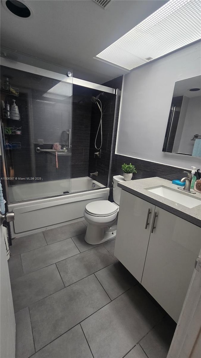 12500 SW 5th Ct Unit 307M, Pembroke Pines, FL 33027 - bathroom featuring vanity, bath / shower combo with glass door, toilet, and tile patterned floors