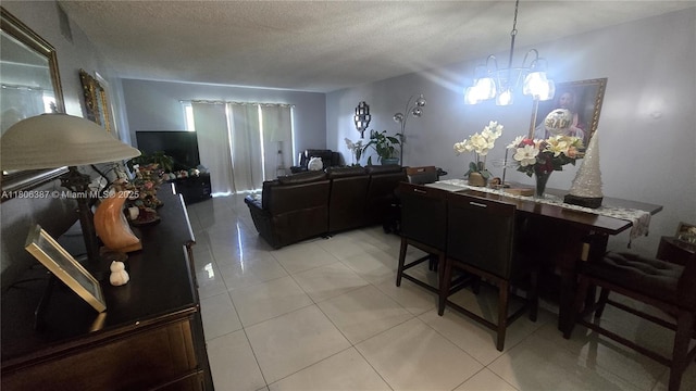 12500 SW 5th Ct Unit 307M, Pembroke Pines, FL 33027 - dining area with a chandelier, light tile patterned floors, and a textured ceiling