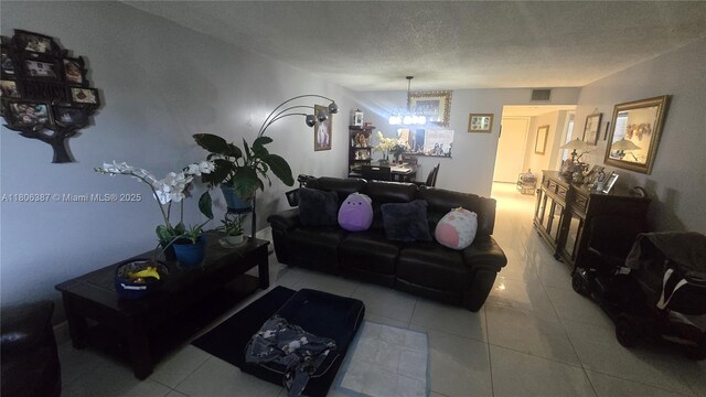 12500 SW 5th Ct Unit 307M, Pembroke Pines, FL 33027 - living area featuring a chandelier, tile patterned flooring, and a textured ceiling