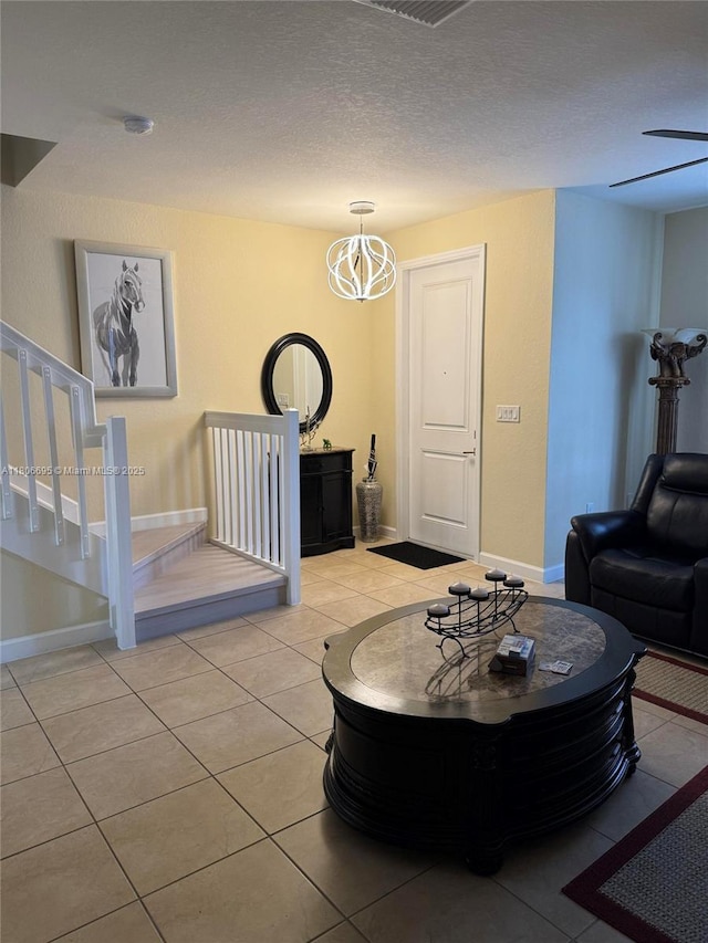 11564 SW 151st Ave, Miami, FL 33196 - living room featuring light tile patterned floors, a chandelier, stairway, baseboards, and a textured ceiling