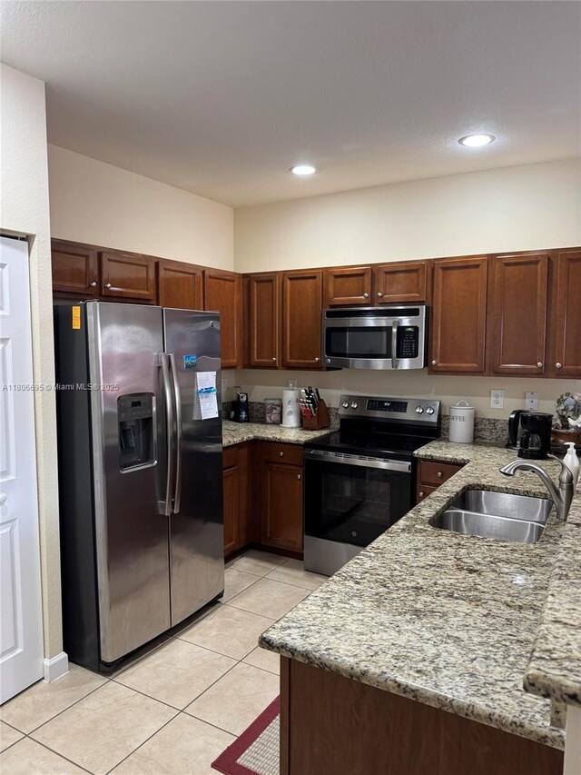 11564 SW 151st Ave, Miami, FL 33196 - kitchen featuring appliances with stainless steel finishes, a sink, light stone countertops, light tile patterned floors, and recessed lighting