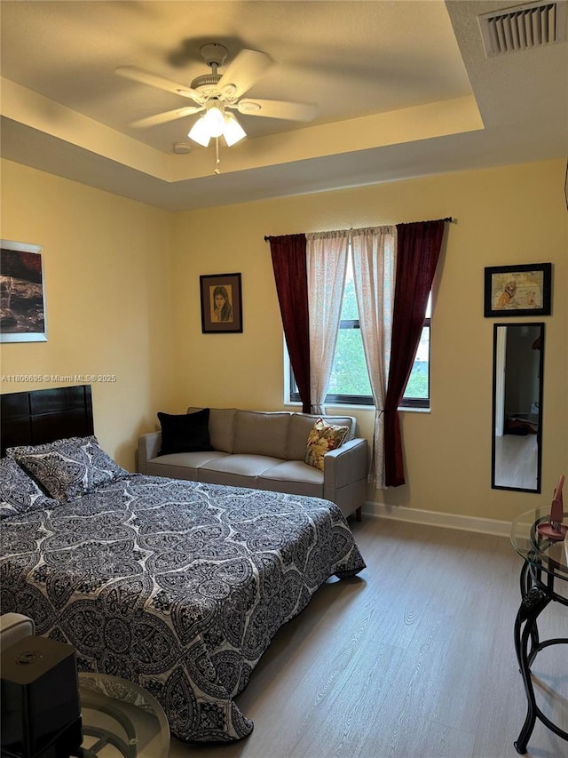 11564 SW 151st Ave, Miami, FL 33196 - bedroom with a tray ceiling, wood finished floors, baseboards, and a ceiling fan