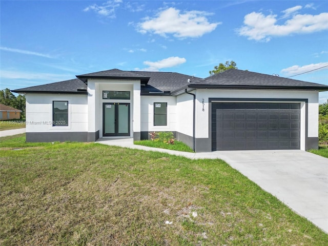 2518 26th St W, Lehigh Acres, FL 33971 - view of front facade with stucco siding, a garage, a front lawn, french doors, and driveway