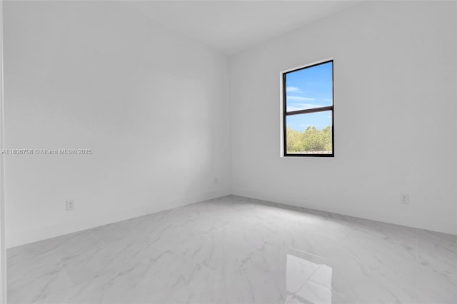 2518 26th St W, Lehigh Acres, FL 33971 - spare room featuring marble look tile flooring and baseboards