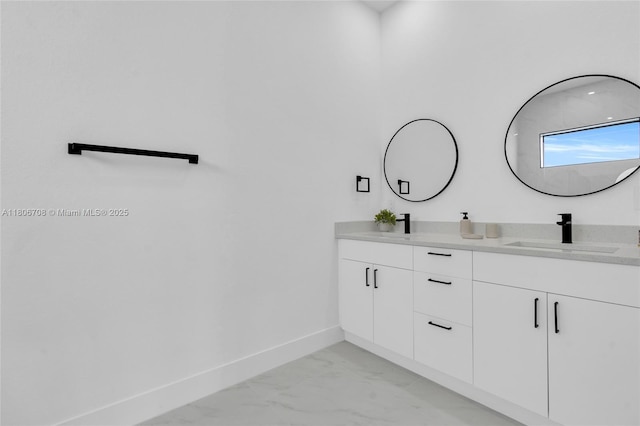 2518 26th St W, Lehigh Acres, FL 33971 - bathroom with marble finish floors, baseboards, and double vanity
