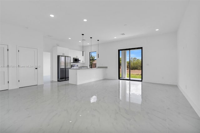 2518 26th St W, Lehigh Acres, FL 33971 - unfurnished living room with light marble finish flooring and recessed lighting