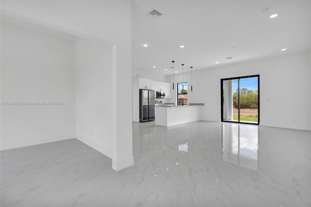 2518 26th St W, Lehigh Acres, FL 33971 - unfurnished living room featuring light marble finish floors, recessed lighting, and baseboards