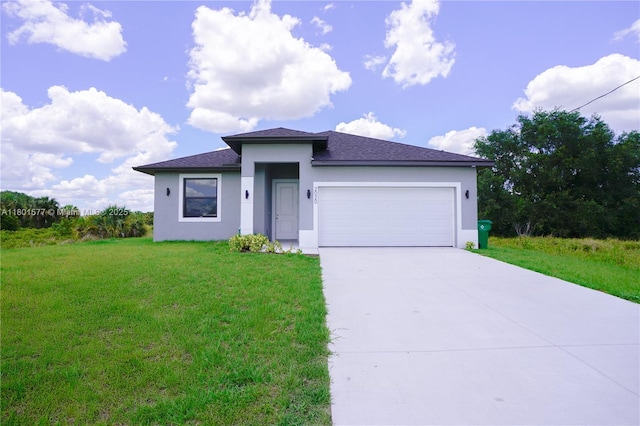 2020 S Montana Cir, La Belle, FL 33935 - prairie-style house with stucco siding, an attached garage, a front yard, concrete driveway, and roof with shingles