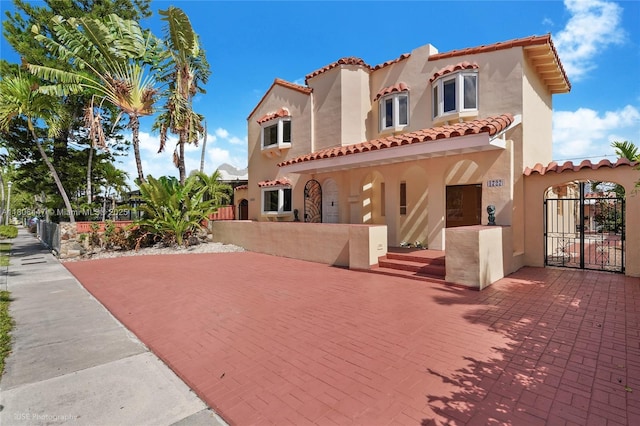 1727 SW 11th Ter, Miami, FL 33135 - mediterranean / spanish-style house featuring a gate, a tile roof, and stucco siding