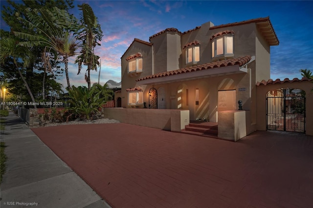 1727 SW 11th Ter, Miami, FL 33135 - mediterranean / spanish-style house with a tile roof, a gate, and stucco siding