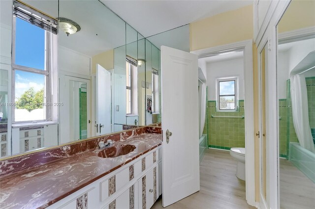 1727 SW 11th Ter, Miami, FL 33135 - full bathroom with toilet, tile walls, wood finished floors, shower / bath combination with curtain, and vanity