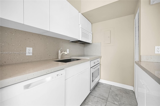 1559 Michigan Ave Unit 303, Miami Beach, FL 33139 - kitchen featuring white appliances, baseboards, a sink, and light stone counters