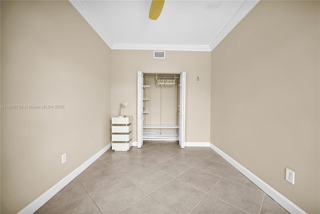 1559 Michigan Ave Unit 303, Miami Beach, FL 33139 - unfurnished bedroom featuring ornamental molding, tile patterned floors, baseboards, ceiling fan, and a closet