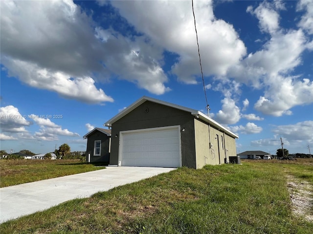 1818 Inwood Rd, La Belle, FL 33935 - view of side of property with stucco siding, concrete driveway, an attached garage, and a lawn