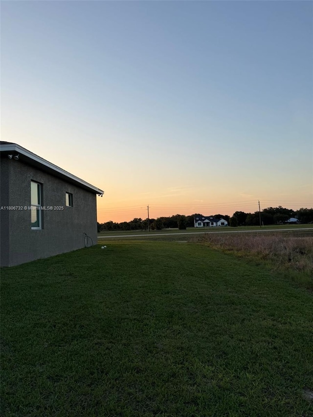 1818 Inwood Rd, La Belle, FL 33935 - yard at dusk with a lawn