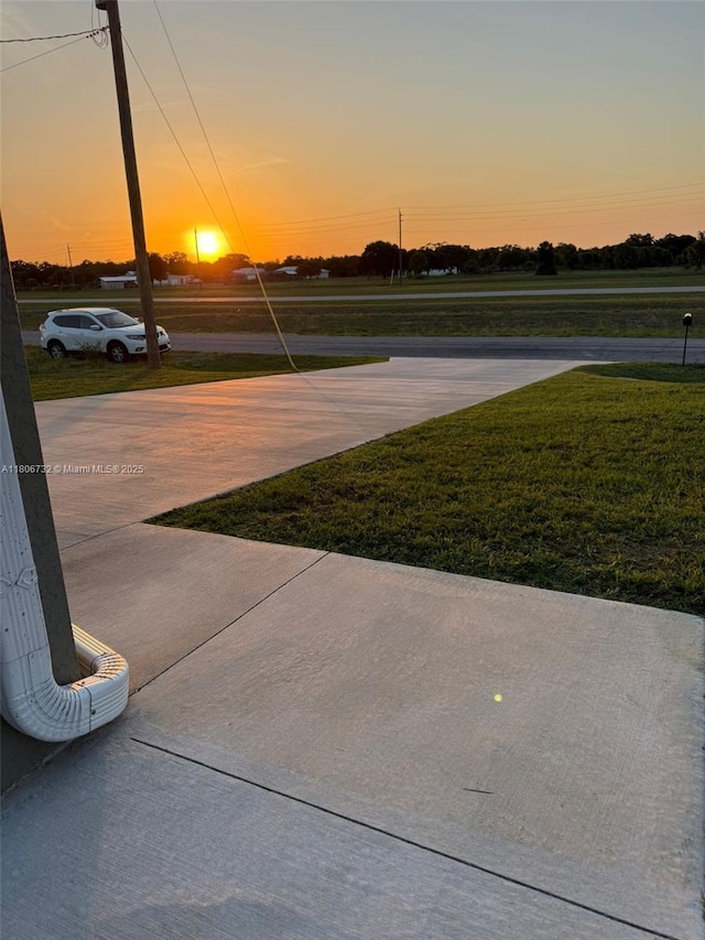 1818 Inwood Rd, La Belle, FL 33935 - patio terrace at dusk with a yard and driveway