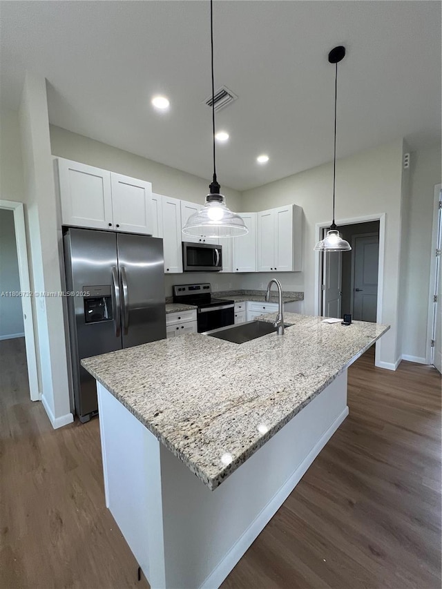 1818 Inwood Rd, La Belle, FL 33935 - kitchen with appliances with stainless steel finishes, baseboards, dark wood finished floors, white cabinetry, and light stone counters
