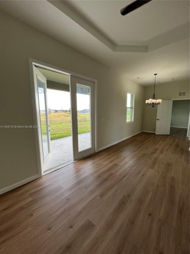 1818 Inwood Rd, La Belle, FL 33935 - unfurnished living room featuring a chandelier, wood finished floors, baseboards, and ceiling fan