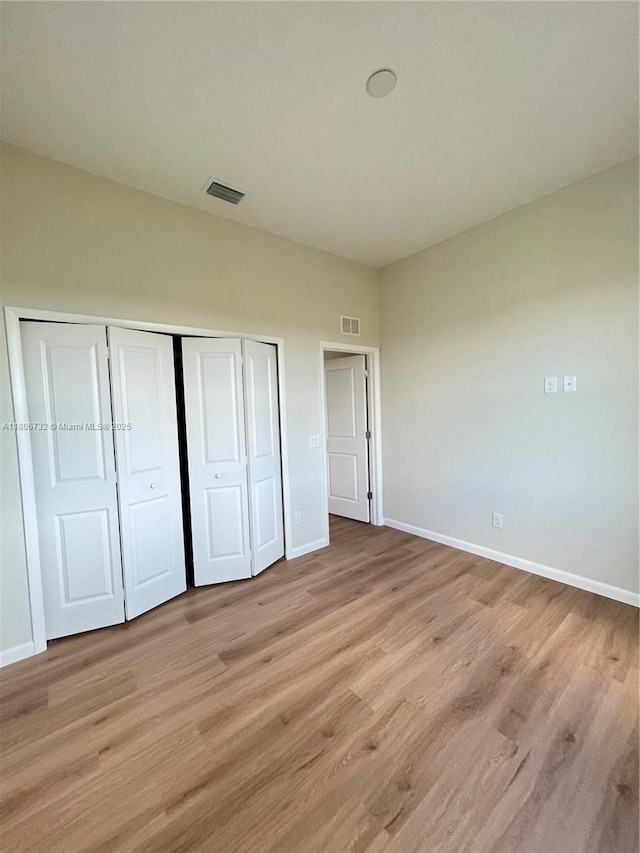 1818 Inwood Rd, La Belle, FL 33935 - unfurnished bedroom with baseboards, light wood-style floors, and a closet