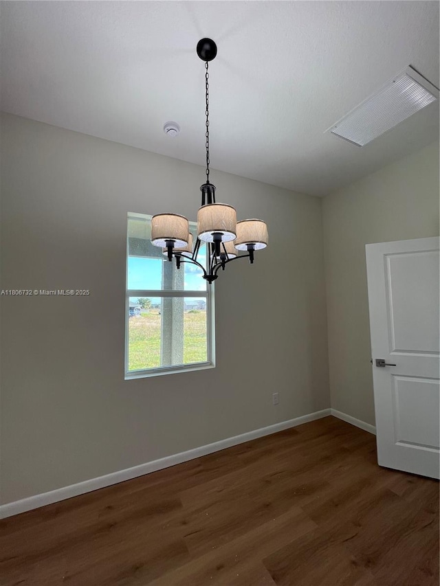 1818 Inwood Rd, La Belle, FL 33935 - unfurnished room featuring wood finished floors, a chandelier, and baseboards