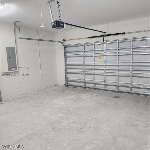 1818 Inwood Rd, La Belle, FL 33935 - garage featuring electric panel and a garage door opener
