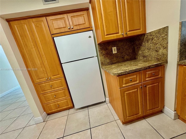 8810 Fontainebleau Blvd Unit 318, Miami, FL 33172 - kitchen with freestanding refrigerator, brown cabinets, light tile patterned floors, and decorative backsplash