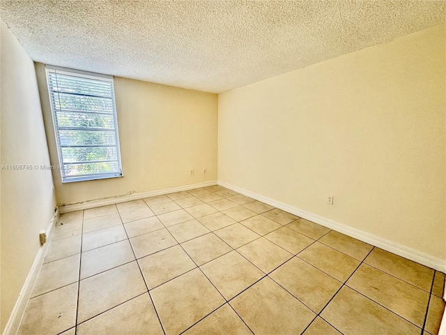 8810 Fontainebleau Blvd Unit 318, Miami, FL 33172 - spare room with light tile patterned floors, a textured ceiling, and baseboards