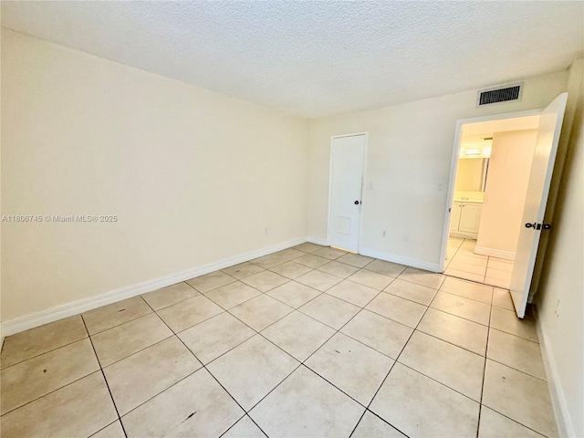 8810 Fontainebleau Blvd Unit 318, Miami, FL 33172 - unfurnished room with light tile patterned floors, a textured ceiling, and baseboards