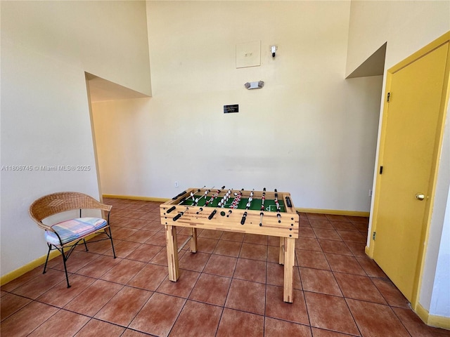 8810 Fontainebleau Blvd Unit 318, Miami, FL 33172 - recreation room with tile patterned flooring, baseboards, and a high ceiling
