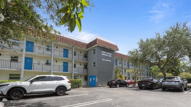 8605 W Sample Rd Unit 202, Coral Springs, FL 33065 - view of building exterior featuring uncovered parking