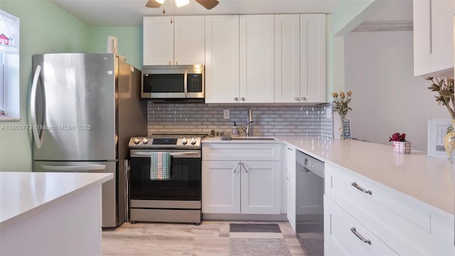 8605 W Sample Rd Unit 202, Coral Springs, FL 33065 - kitchen featuring appliances with stainless steel finishes, a sink, a ceiling fan, light countertops, and white cabinetry