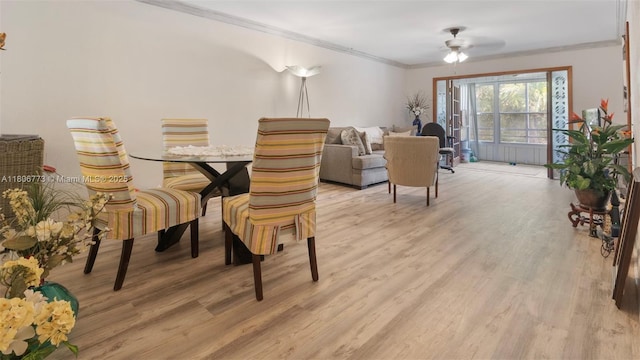 8605 W Sample Rd Unit 202, Coral Springs, FL 33065 - dining space with crown molding, light wood-type flooring, and ceiling fan