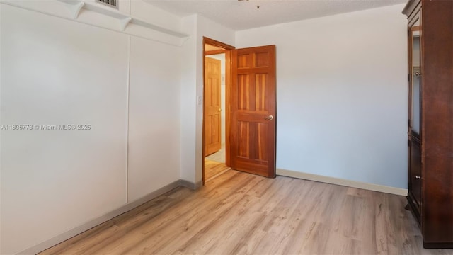 8605 W Sample Rd Unit 202, Coral Springs, FL 33065 - unfurnished bedroom featuring light wood-style flooring, baseboards, and a closet