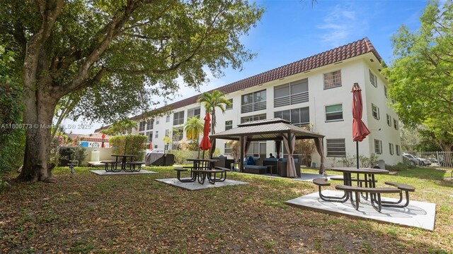 8605 W Sample Rd Unit 202, Coral Springs, FL 33065 - back of property featuring a tile roof, a patio, a gazebo, and stucco siding
