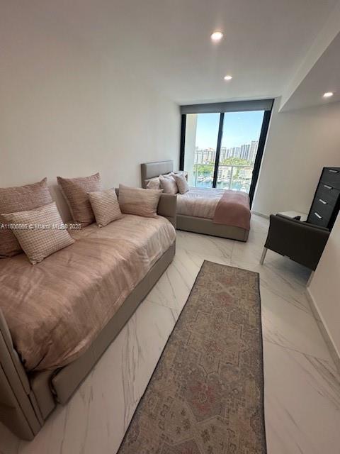 19500 Turnberry Way Unit 12A, Aventura, FL 33180 - bedroom with a wall of windows, light marble finish flooring, access to exterior, and recessed lighting
