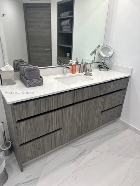 19500 Turnberry Way Unit 12A, Aventura, FL 33180 - bathroom featuring marble look tiles, vanity, and baseboards