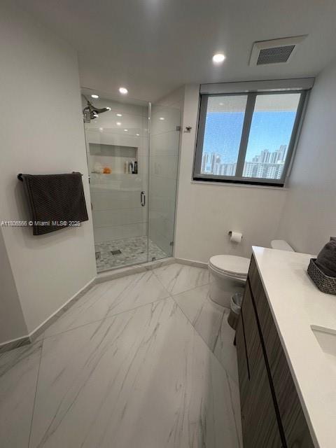 19500 Turnberry Way Unit 12A, Aventura, FL 33180 - bathroom featuring baseboards, vanity, a stall shower, toilet, and marble finish floors